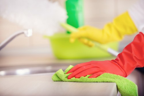 Cleaner treating a stained carpet in a local London flat